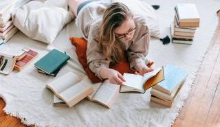 Liegende Frau mit Buch in den Händen. Aufmacherbild Bücherabo der Buchhandlungen Leporello und Stöger-Leporello.